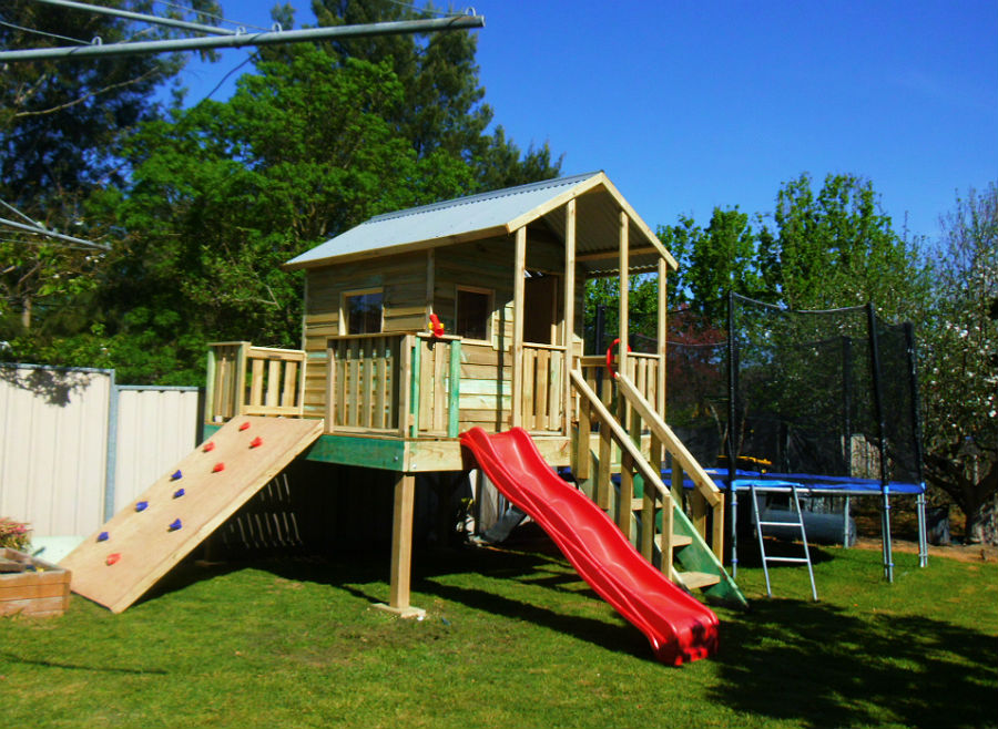 cubby with covered verandah, slide and rock climbing wall
